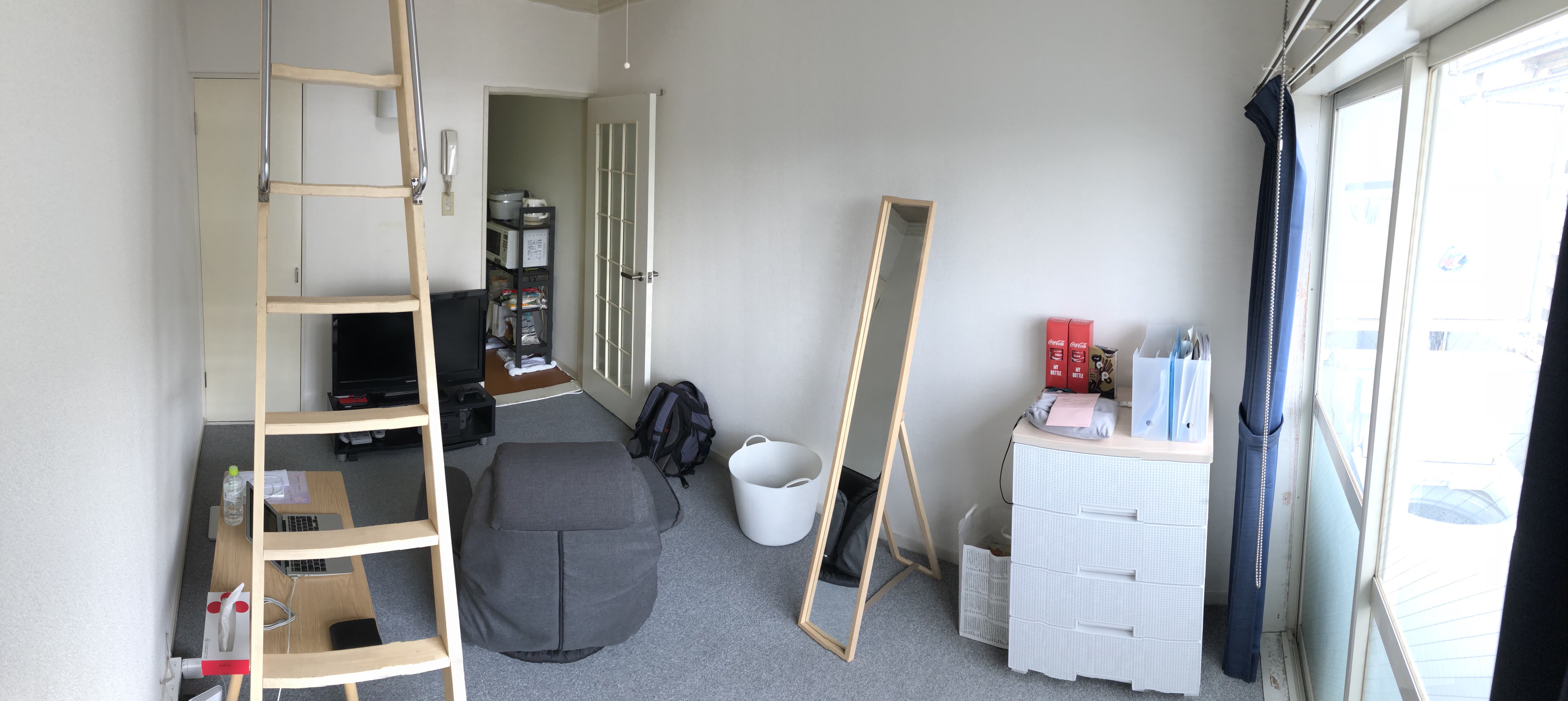 (Caption) Panorama shot! Some things that were not visible in the previous shot include storage closet on the left side, obviously the TV and a TV stand in the middle and Kumi’s cabinet on the left side.